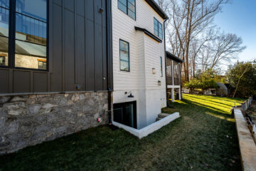 The entrance to a basement on the side of a modern home.