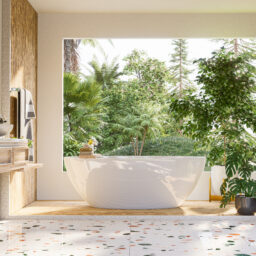 A modern bathroom interior design with a large window immersing the room with natural light and nature.