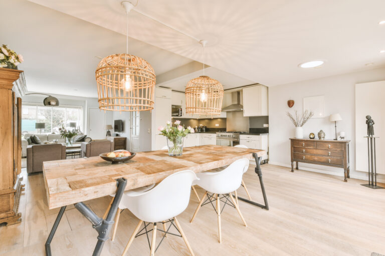 A modern living room and kitchen decorated with natural and organic furniture.