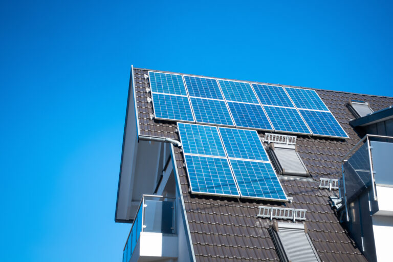 Solar panels on a roof with metal shingles.